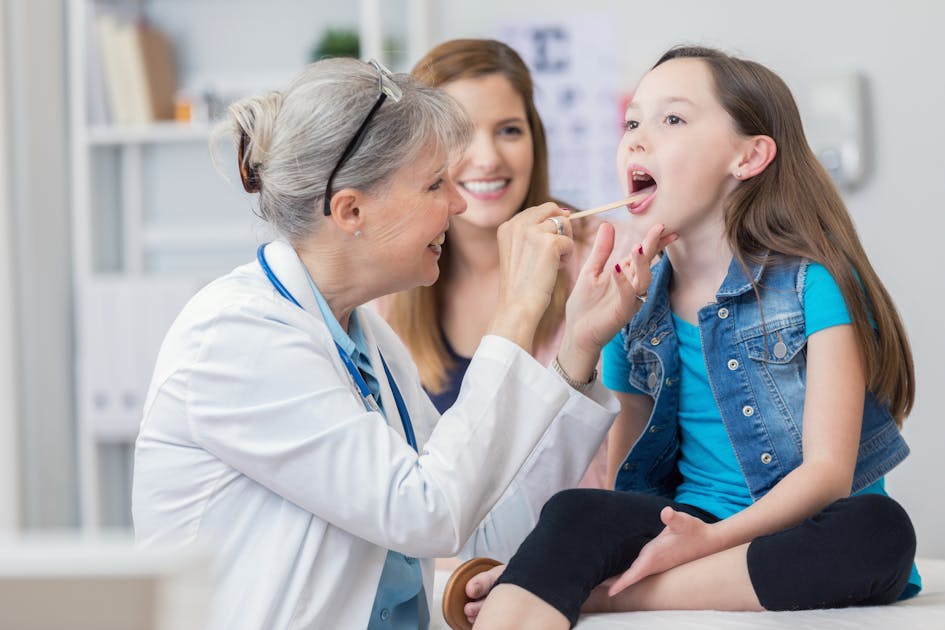Mom checking little Patient's throat with Wooden